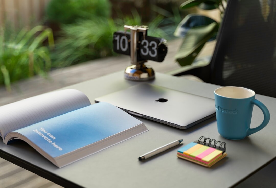 Organized desk with laptop, notebook and coffee cup for leadership planning